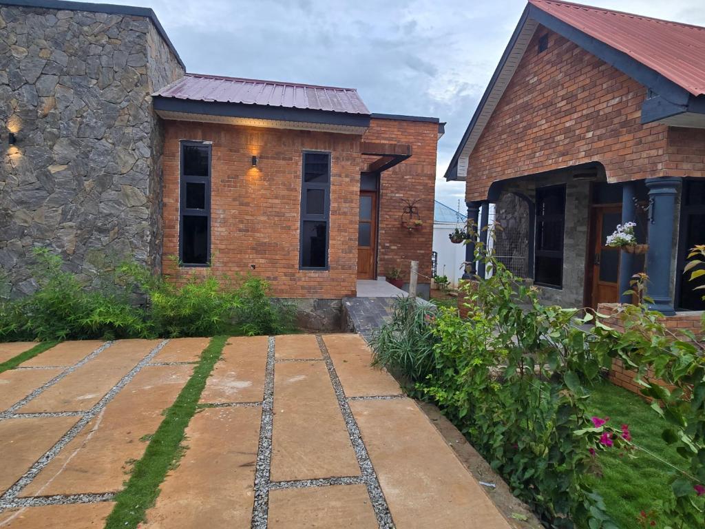 a brick house with a walkway in front of it at Verified Stone House in Dodoma