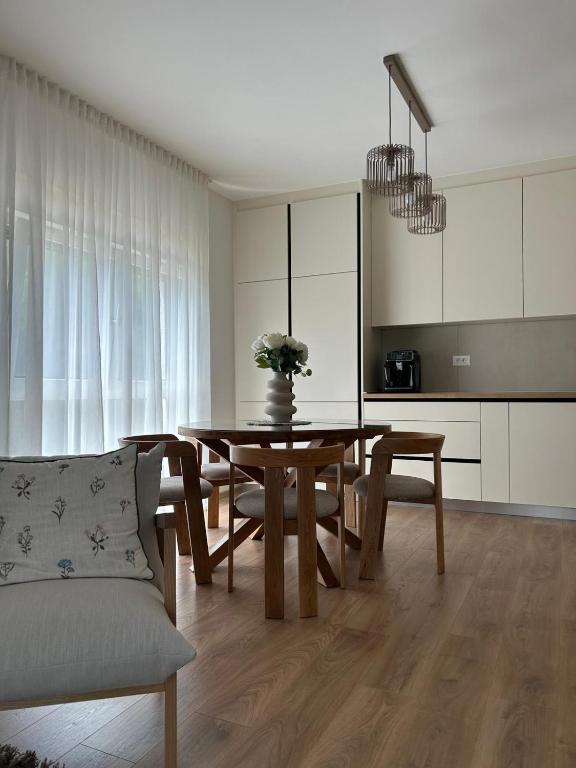 a dining room with a table and a couch at Apartman Lami in Krapina
