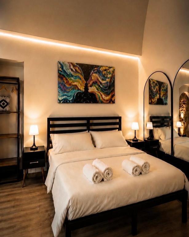 a bedroom with a large bed with towels on it at Domus Regina Sforza in Capurso