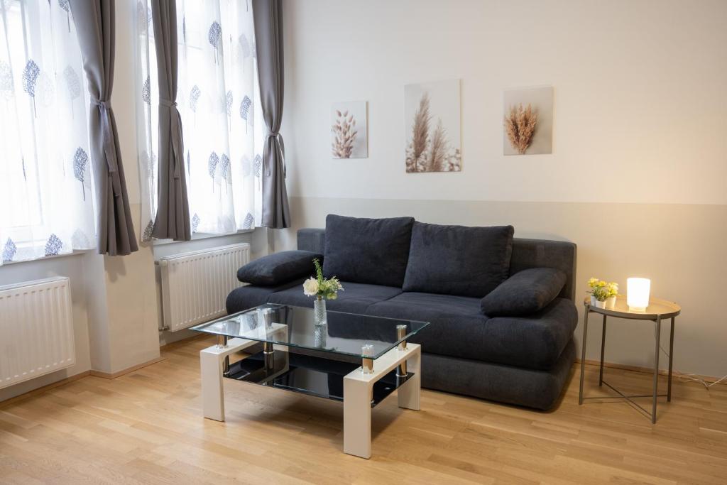 a living room with a couch and a table at Paky Appartements 00209 in Vienna