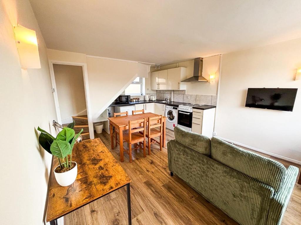 a living room with a couch and a table at The Lodge Mews in Shaw Mills