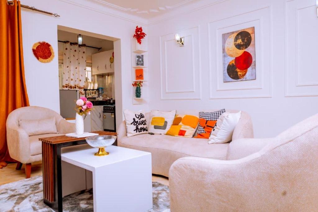 a living room with a couch and a table at LYZ HOMES Ltd in Kampala