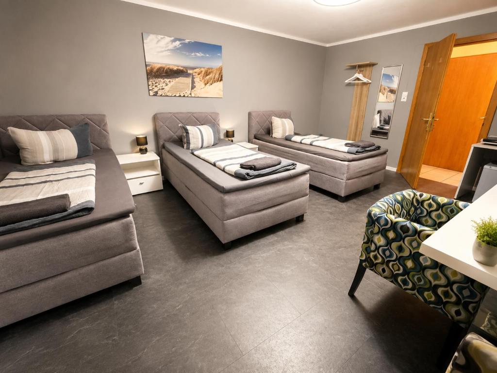 a living room with two couches and a couch at Pension Reiter in Blomberg
