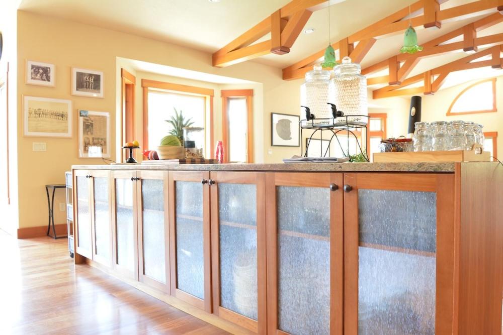 a kitchen with a counter with glass doors at Corbin B&B in Corvallis