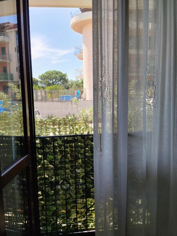 a window with a view of a garden at Casa Vacanze Daniele in Pontecagnano