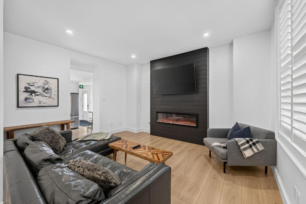 a living room with a couch and a fireplace at The 1883 Century Flat Suite in Collingwood