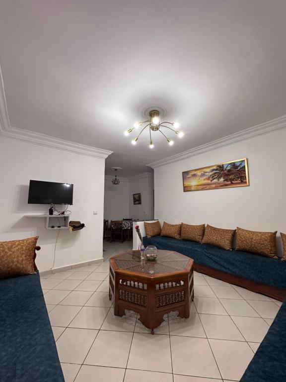 a living room with a couch and a table at Appartement Nadin in Martil