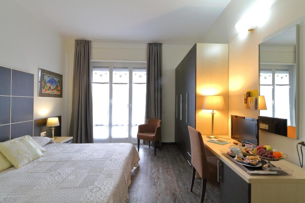 Postel nebo postele na pokoji v ubytování Hotel Ferrari