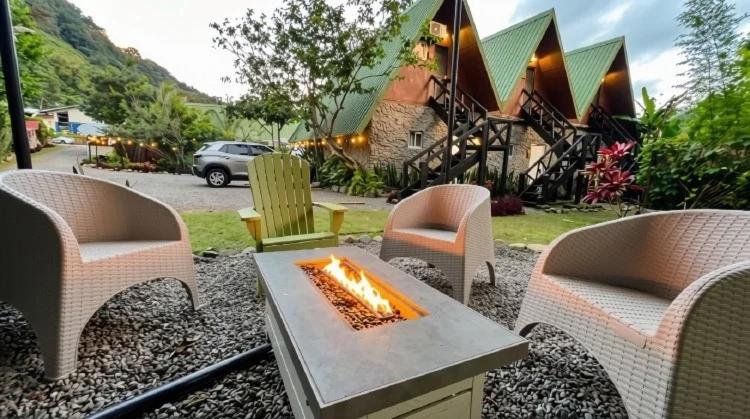 a patio with chairs and a table with a fire pit at Boquete Firefly Inn in Boquete