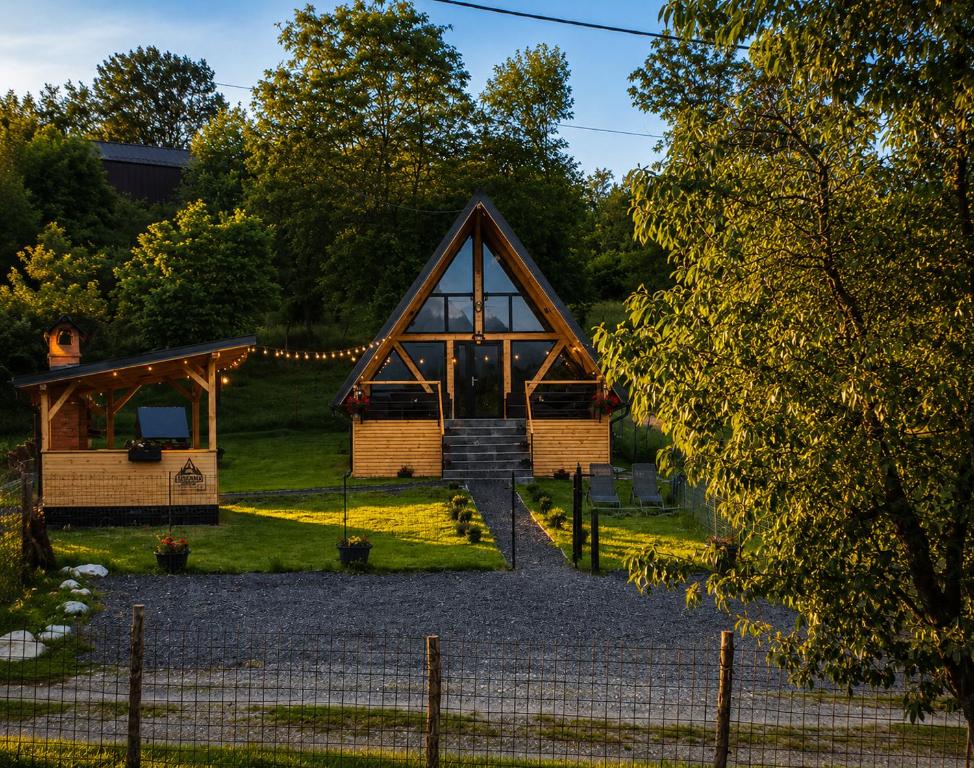 a cabin in the woods with the front door open at Cabana Bucegi View A-Frame Bran in Predeluţ