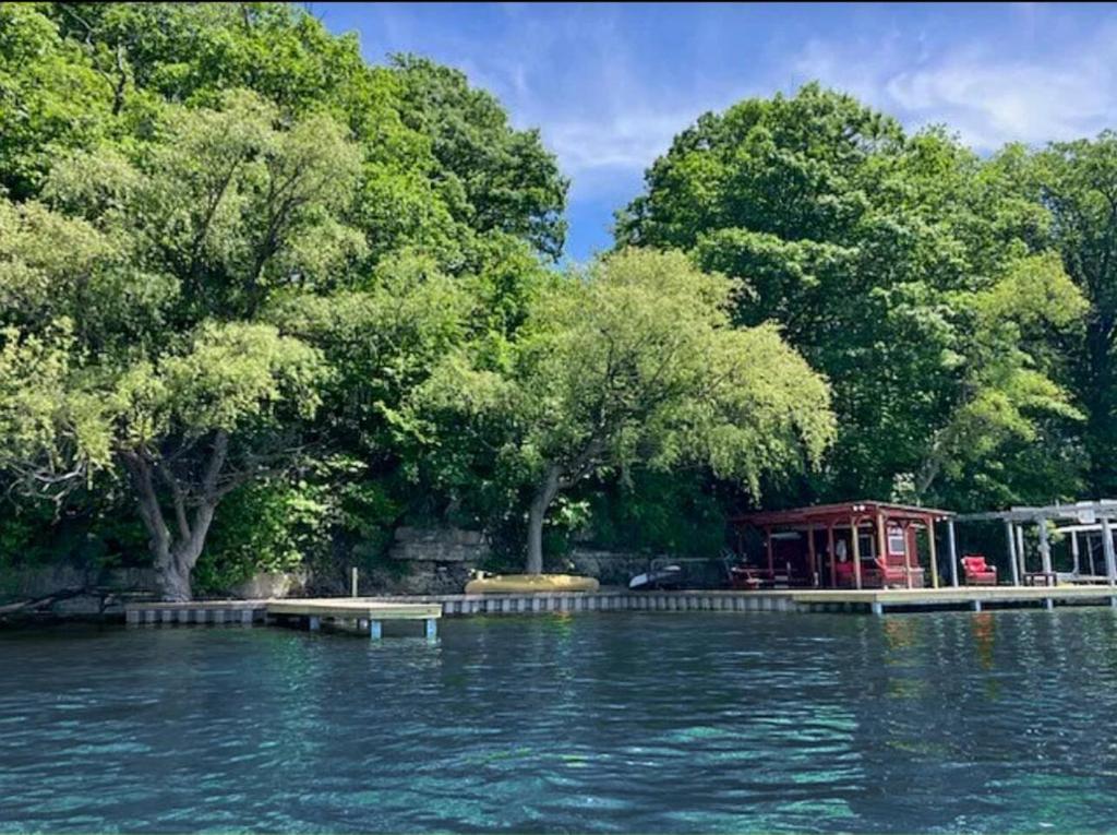 a large body of water with trees and a building at Cayuga lake cottage with private lake access in Washingtonville