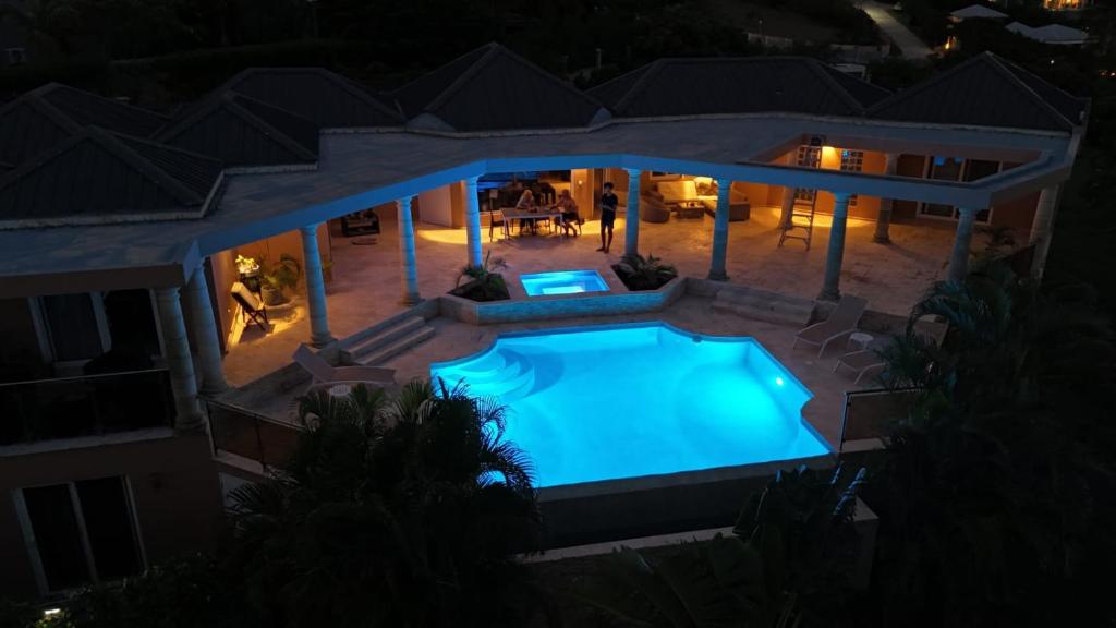 an overhead view of a swimming pool at night at C'RENITY VILLA in Cul de Sac