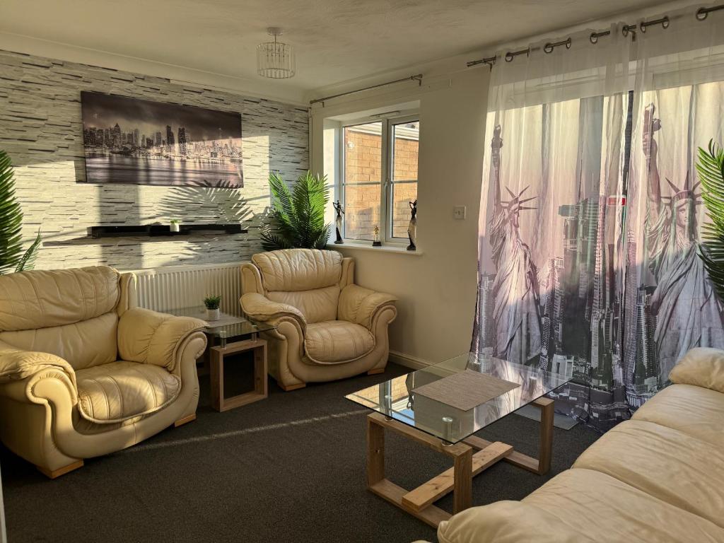a living room with two couches and a table at Stony Apartment House in Doncaster