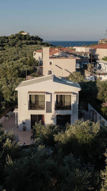 a white house with trees in front of it at AnaRose Zante Villa-by Sakis and Sam in Planos