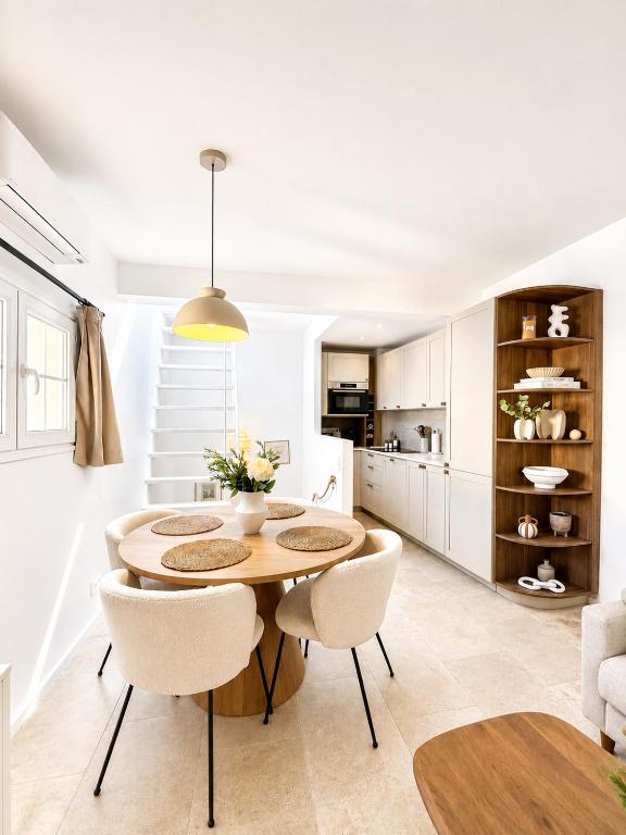 a kitchen and dining room with a table and chairs at Charming house with rooftop - Gassin in Gassin