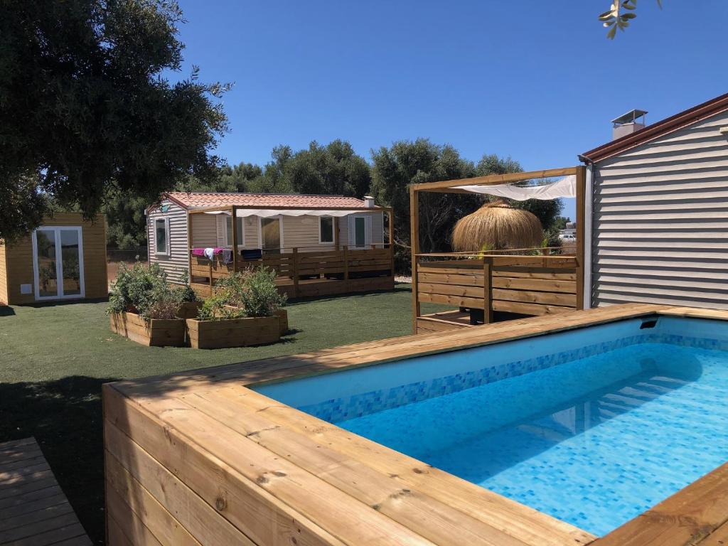 a backyard with a swimming pool and a house at Beach Break Bungalows Playa El Palmar in Cádiz