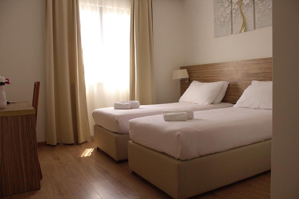 a hotel room with two beds and a window at Hotel Luna in Međugorje