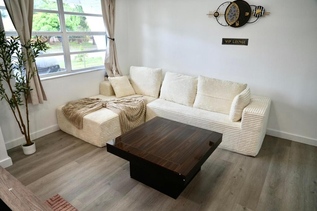 a living room with a white couch and a coffee table at Private Pool Near Guitar Hotel & Beach in Hollywood