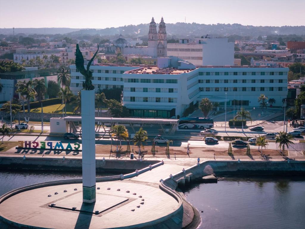 a view of a city with a statue in the foreground at Hotel Katuxlan in Campeche