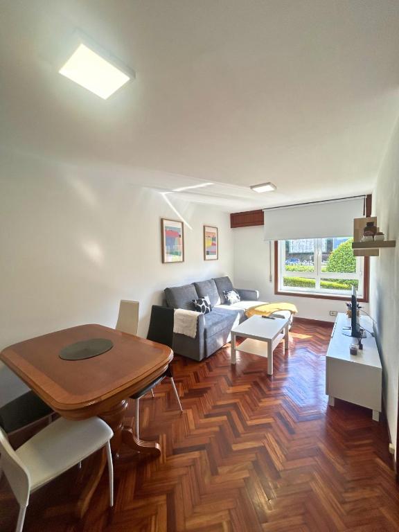 a living room with a table and a couch at Apartamento en A Coruña in A Coruña