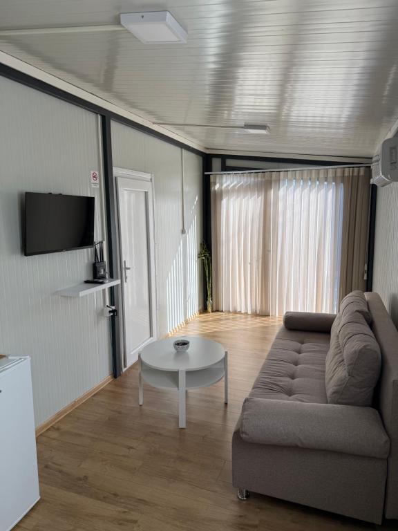 a living room with a couch and a table at The Nest in Mitrovići