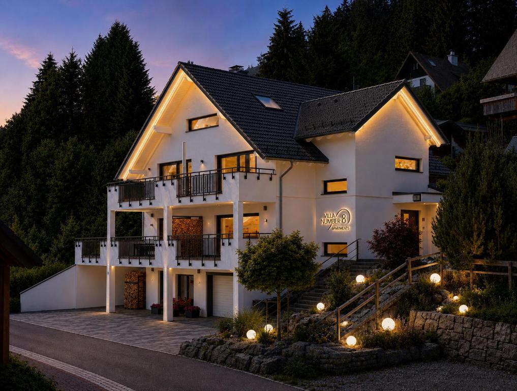 a large white house with lights in front of it at Villa Number 8 in Feldberg