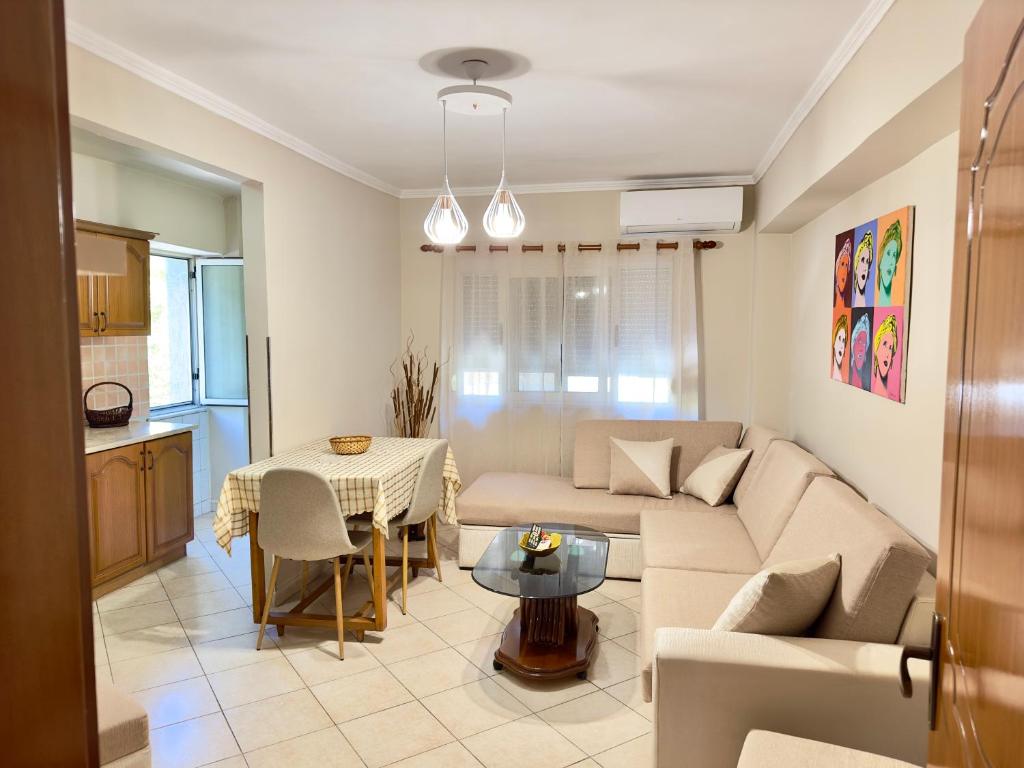 a living room with a couch and a table at Luna Apartment in Durrës