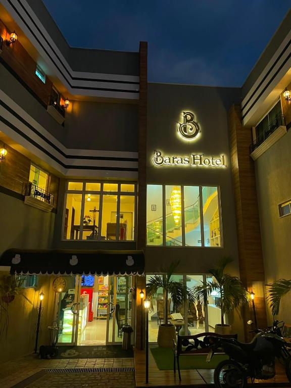 a store front of a barneys hotel at night at Bara's Hotel in Bom Conselho