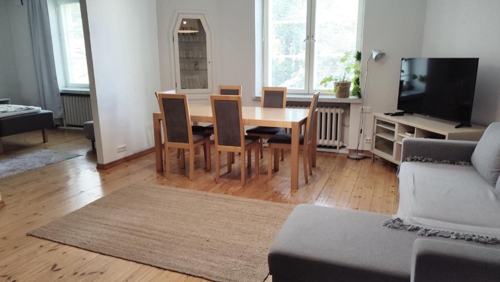 a living room with a wooden table and chairs at HHH Perfect location right in Helsinki center, walking distance to Kamppi and railway station in Helsinki
