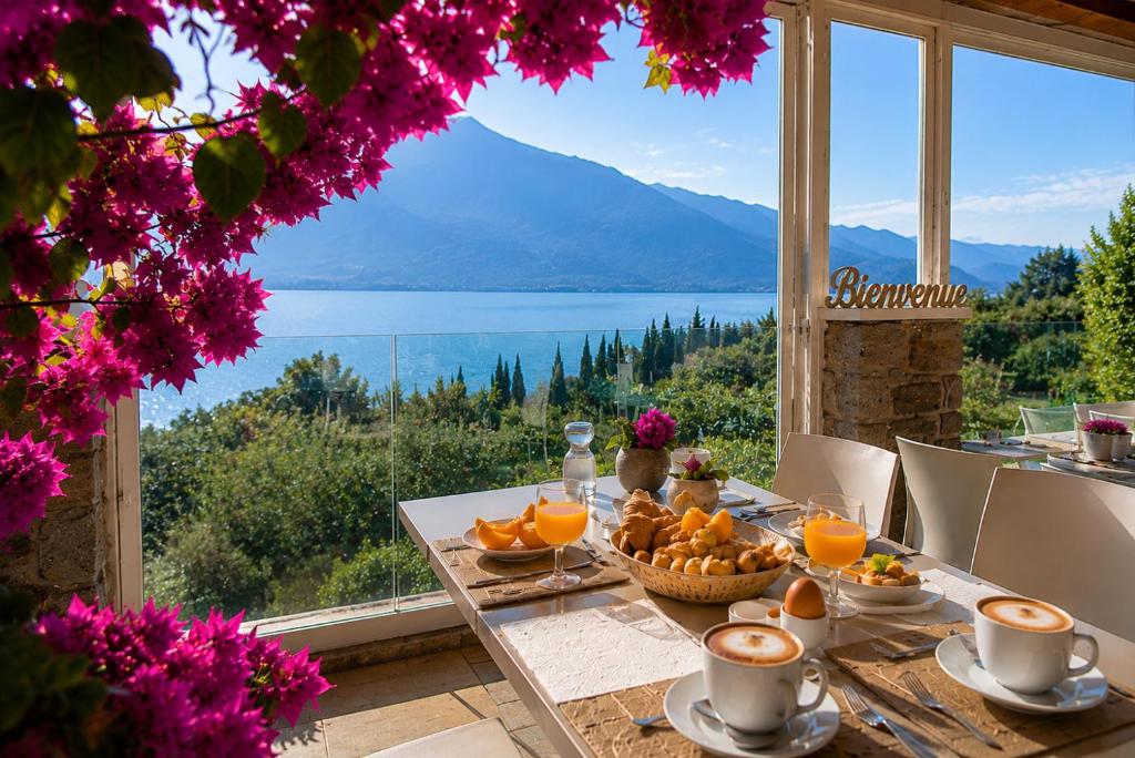 a table with a basket of oranges and a view of a lake at La Cascata Negli Ulivi in Toscolano Maderno