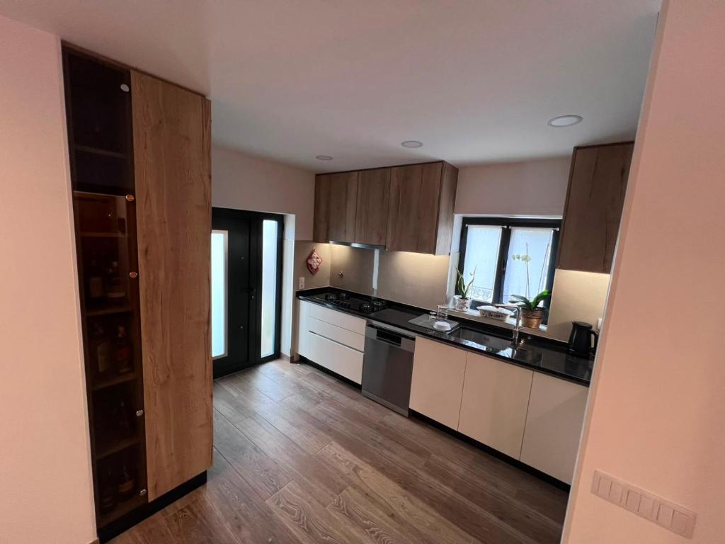 a large kitchen with wooden cabinets and appliances at Casa do Rio in Freixieiro de Soutelo