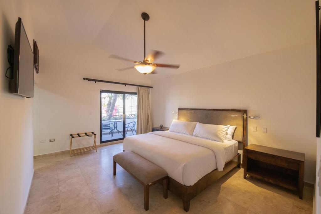a bedroom with a bed and a ceiling fan at Rooftop Oasis Steps from the Malecon in La Paz