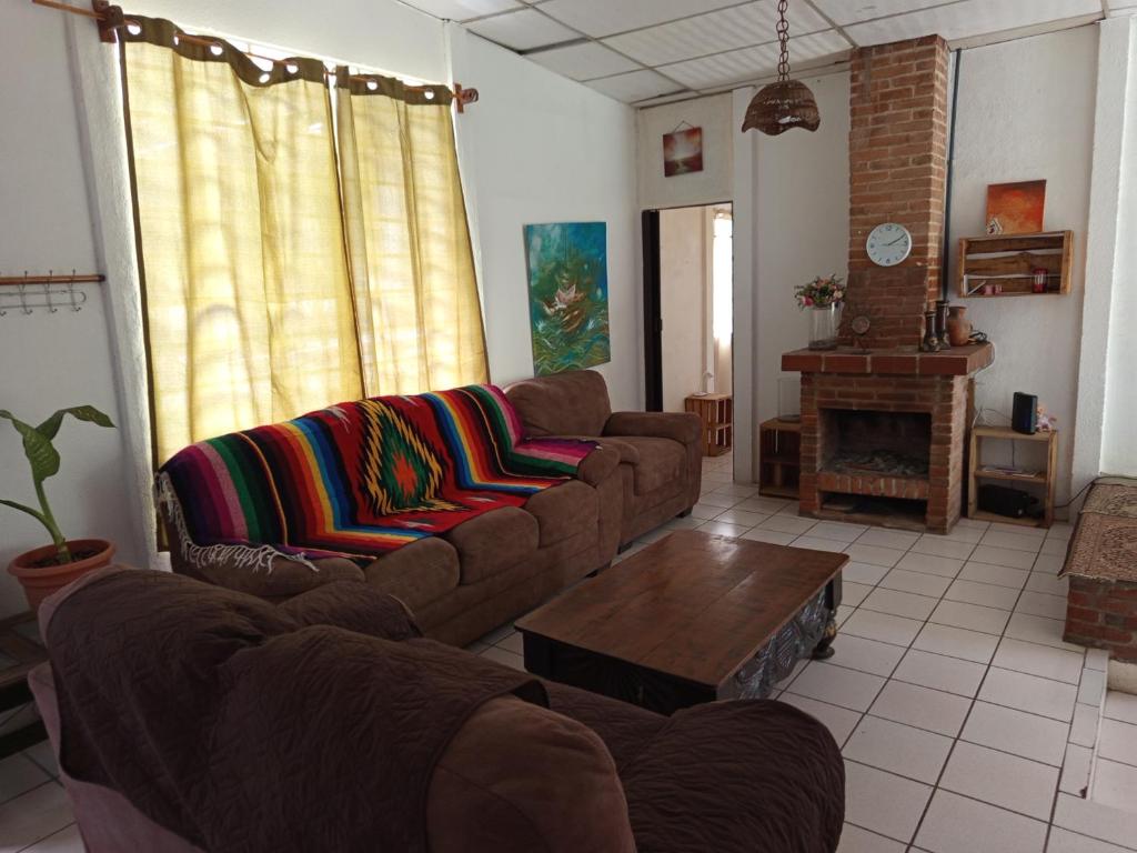 a living room with two couches and a coffee table at Granja Triple A in Guatemala