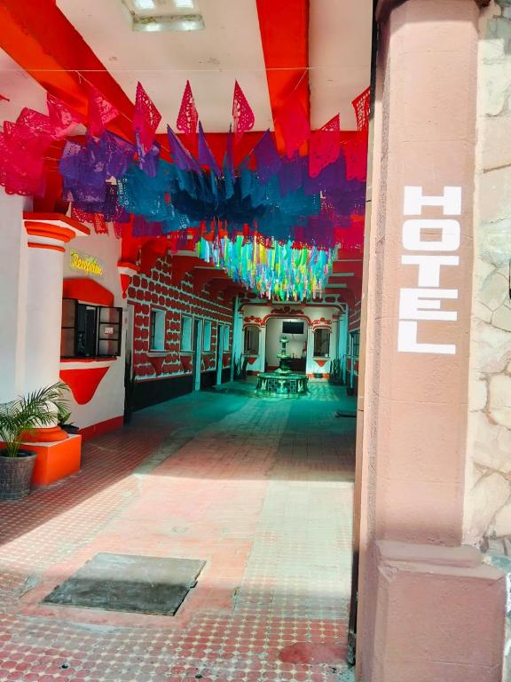 a hallway of a building with red and blue at Hotel Antequera in Oaxaca City