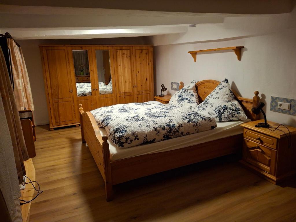 a bedroom with a bed with blue and white sheets at Haus Semmelrodt in Witzenhausen