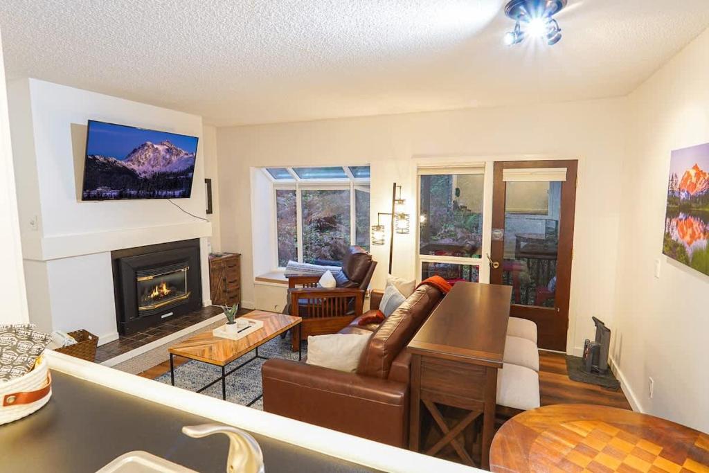 a living room with a couch and a fireplace at Mt Baker Den, Sleeps 4 in Glacier