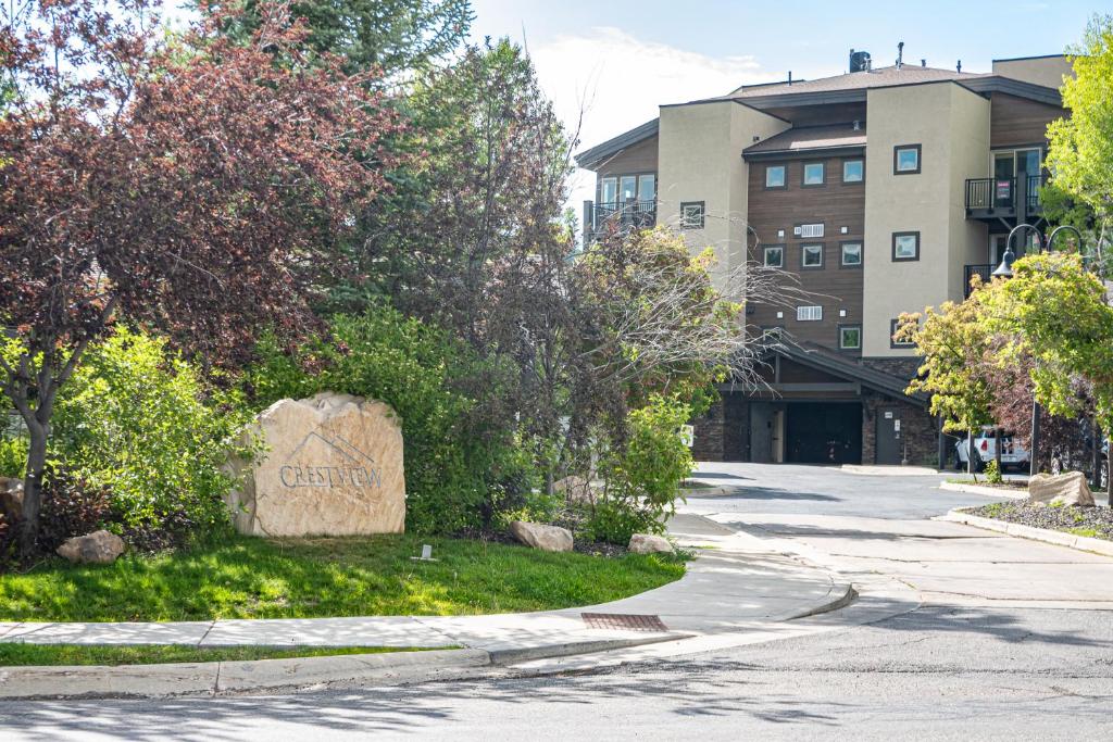 a street in front of a building with a large rock at Crestview Condominiums by All Seasons Resort Lodging in Park City