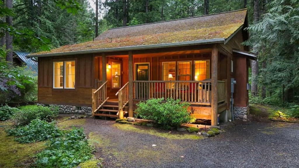 a small wooden cabin in the middle of a forest at Twin Lakes Cabin in Glacier