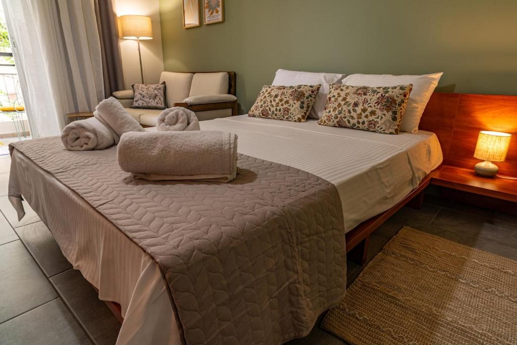 a bedroom with a large bed with two towels on it at Studio74 in Patra