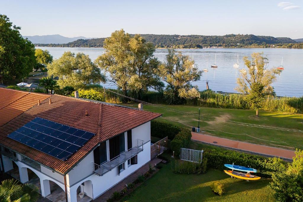a house with a roof with solar panels on it at Un Occhio Sul Lago in Dormelletto