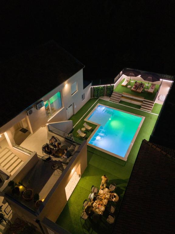 an aerial view of a house with a swimming pool at Villa Bella in Čitluk