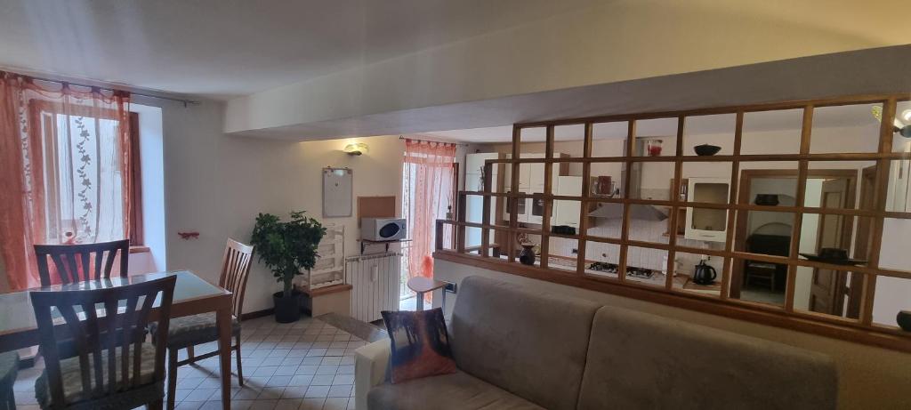 a living room with a couch and a dining room at Deby House in Oggebbio
