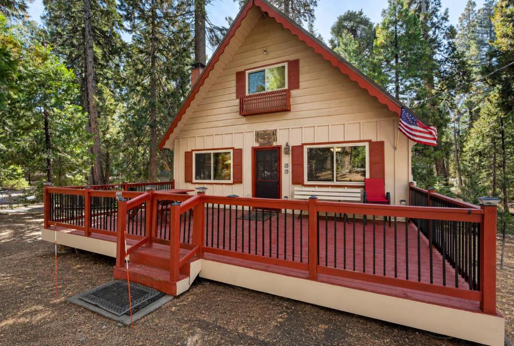 a tiny house with a red railing on a deck at Smoke Tree Hollow AC Pine Air in Shaver Lake