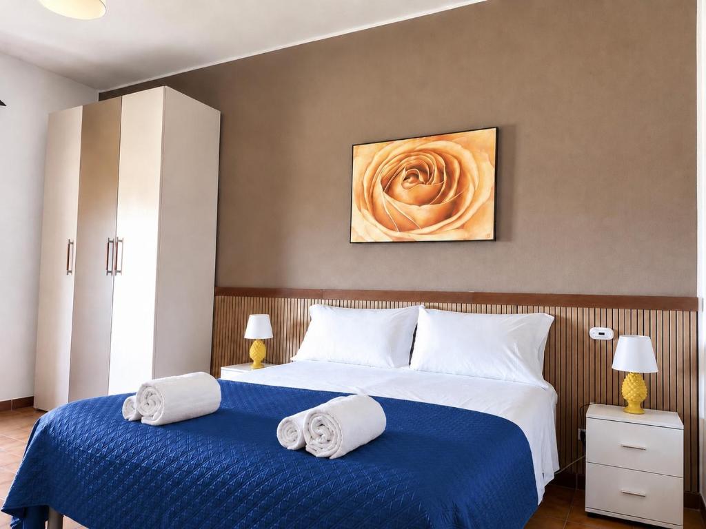 a bedroom with two beds with towels on them at Poseidon Bay Residence in Milazzo