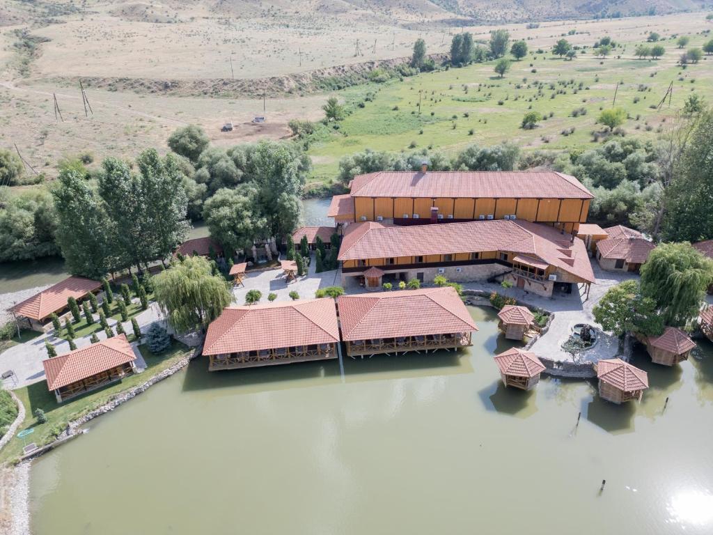 an aerial view of a house on the water at Lchak Hotel in Yeghegnadzor