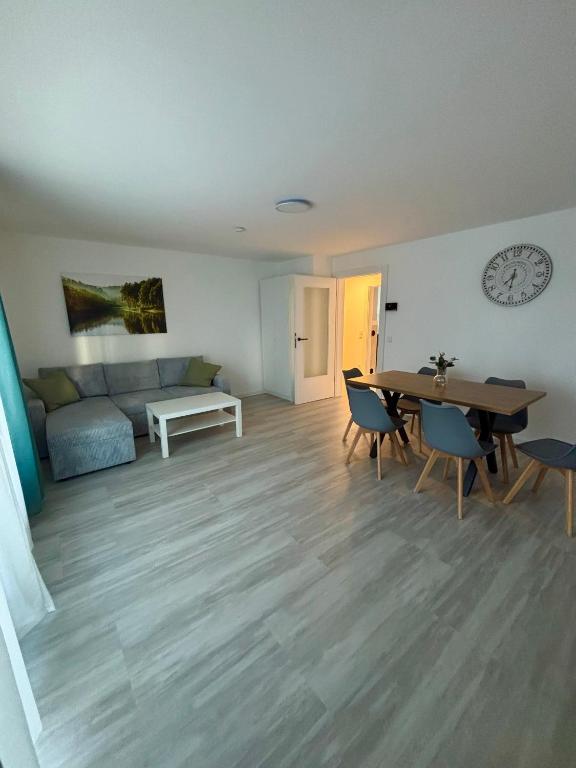 a living room with a table and chairs and a couch at AG Apartments Waiblingen in Waldmühle