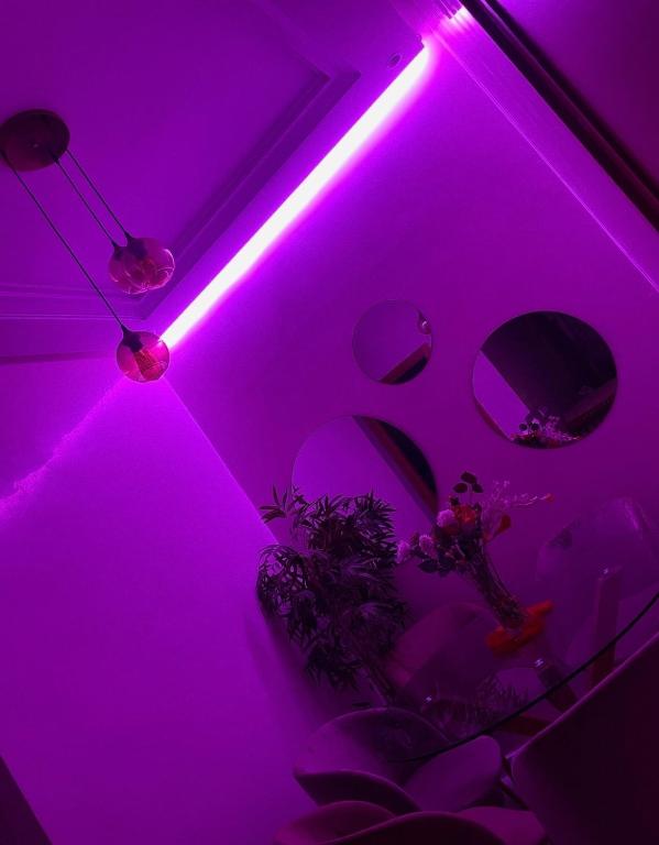 a purple room with a table with a purple light at Basatine in Fez