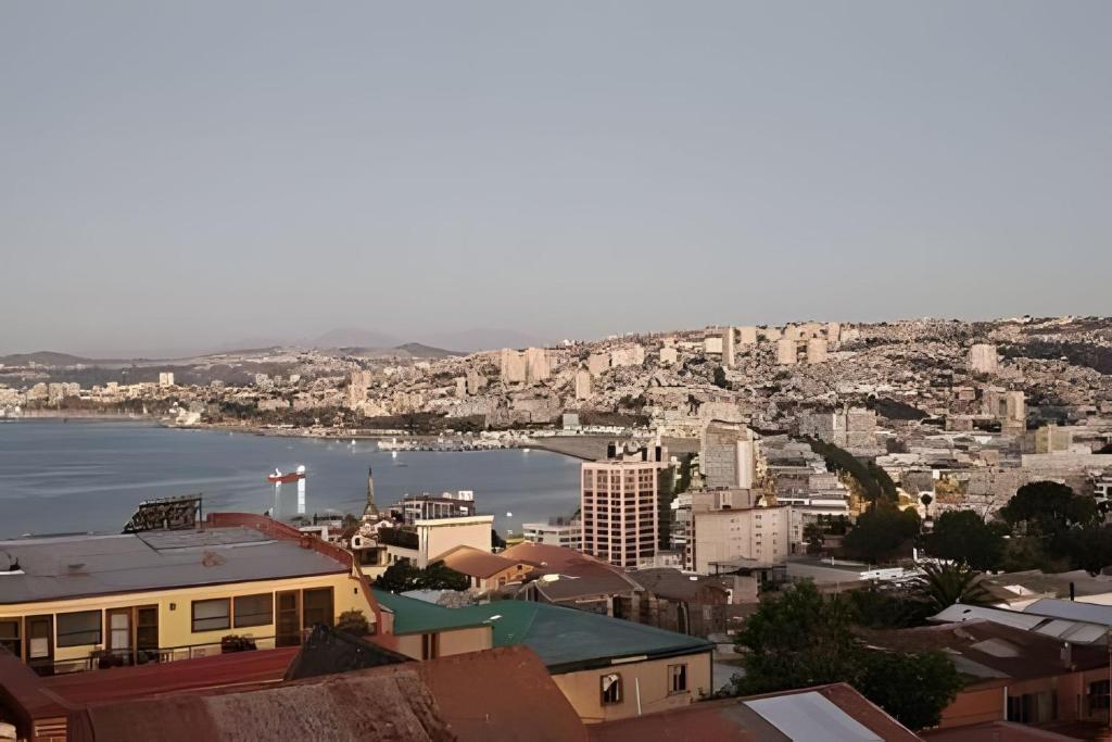 an aerial view of a city with a body of water at Casa Fran Valparaíso | Vive un Hotel Temático in Valparaíso