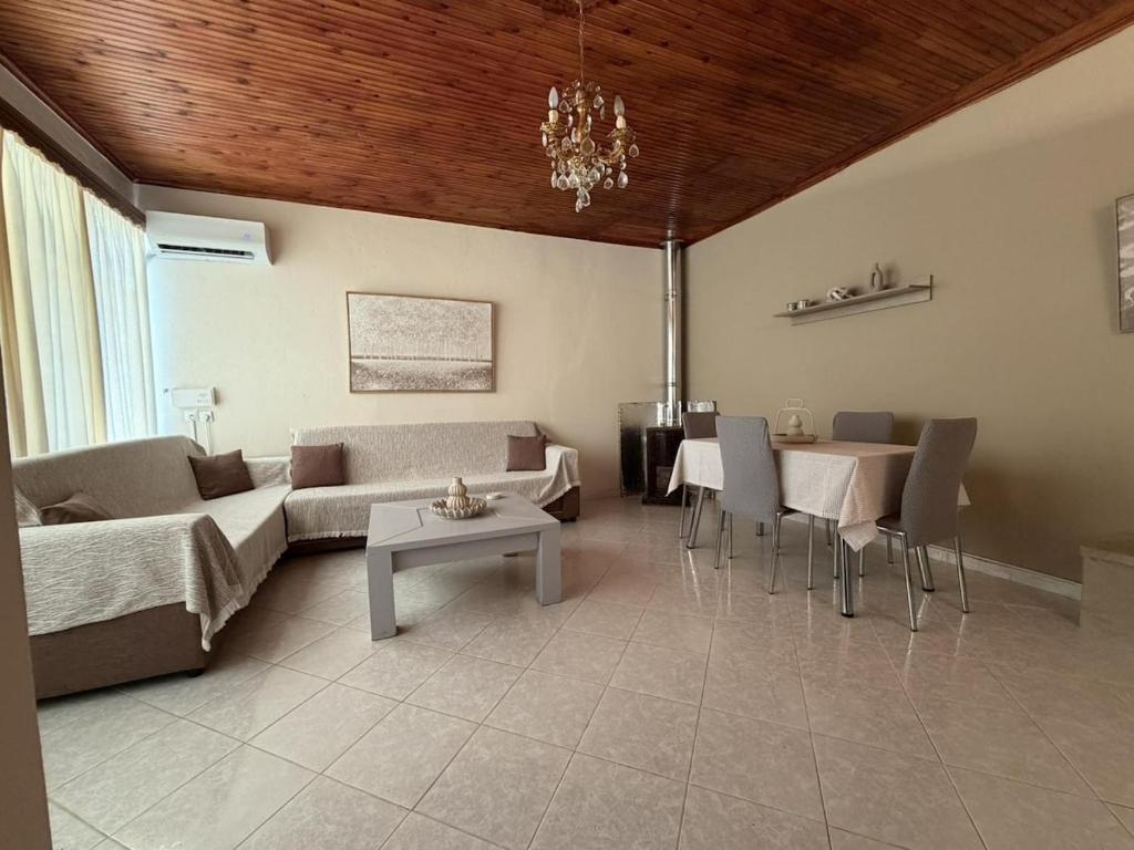 a living room with a couch and a table at Male home in Maletiánoi