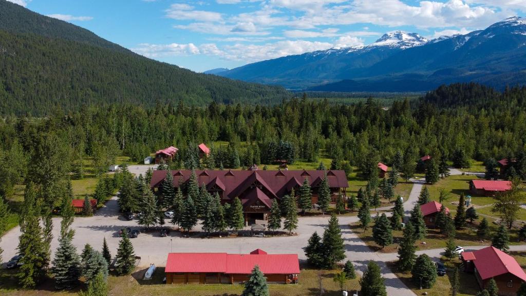 an aerial view of a resort with trees and mountains at Glacier House Hotel & Resort in Revelstoke